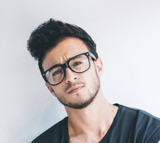 Man with glasses looking serious against white background